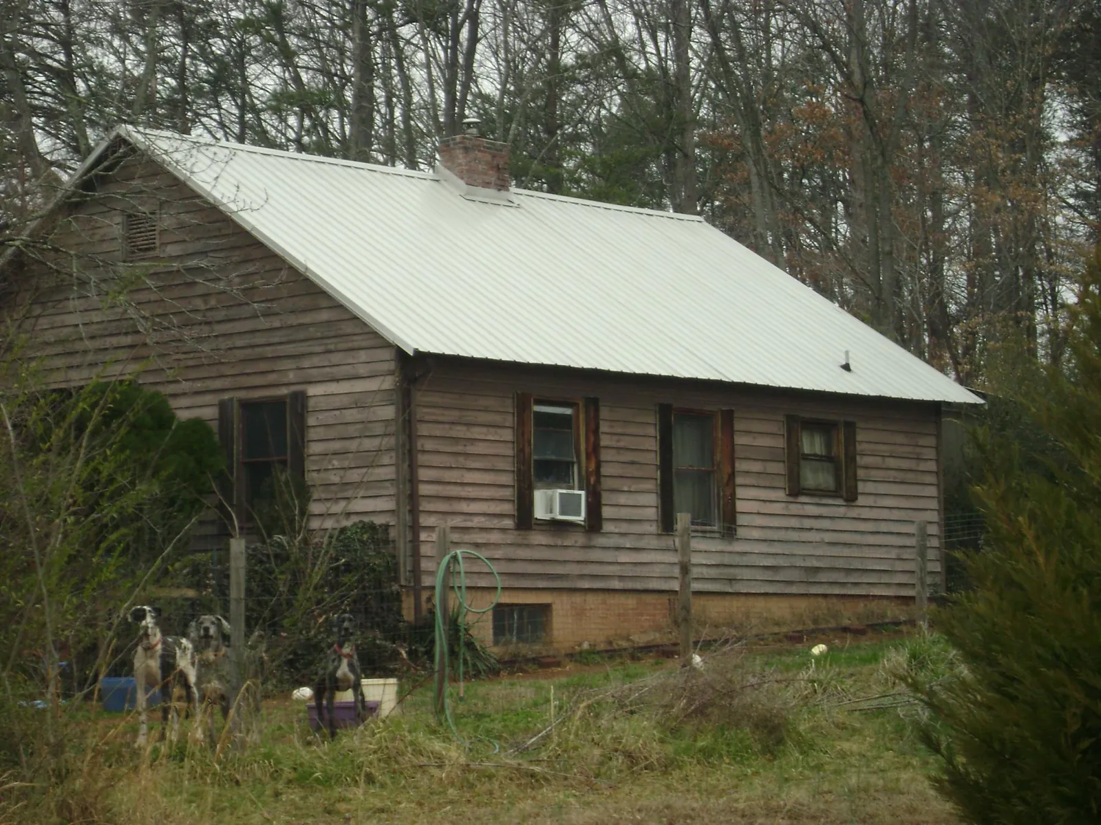White metal roof on an old wood sided farmhouse, from a Metal Roof Installation job in Fall River